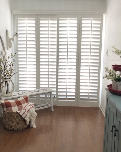 Sliding door shutters in cottage style home